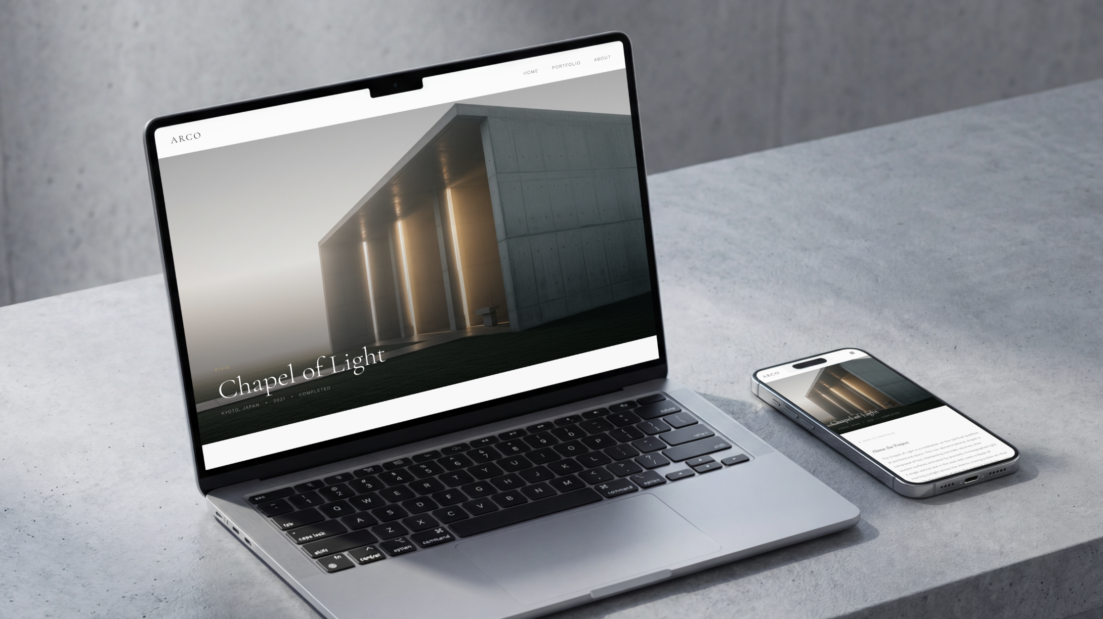 A laptop and phone displaying the homepage of an architecture firm's website. 